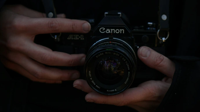 black nikon dslr camera on persons hand